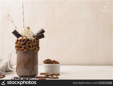front view chocolate milkshake glass with pretzels copy space