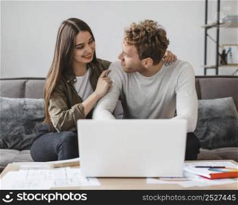 front view couple making plans remodel home together
