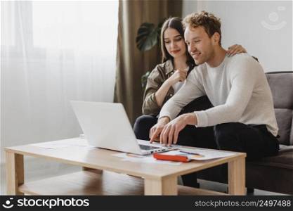front view couple making plans remodel household together