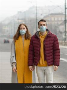 front view couple posing together with medical masks