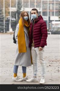 front view couple wearing medical masks