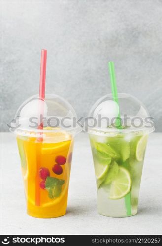 front view cups with soft drinks straws