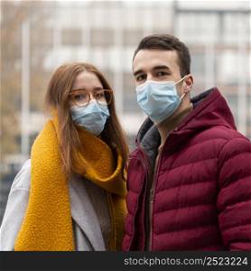 front view cute couple wearing medical masks