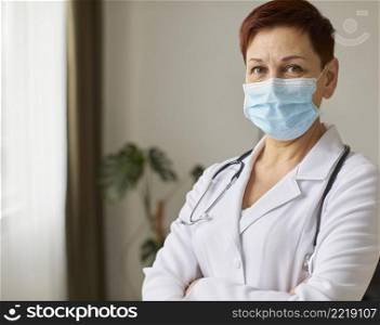 front view elder covid recovery center female doctor with medical mask