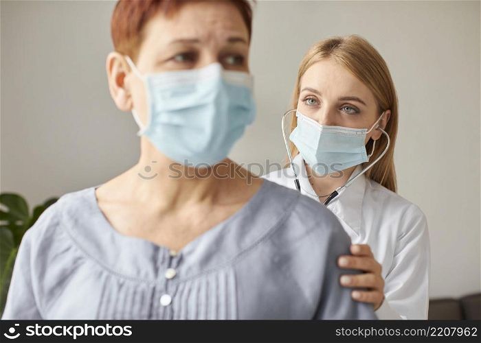 front view elder patient with medical mask covid recovery center female doctor with stethoscope