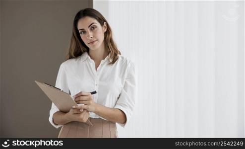 front view elegant businesswoman holding clipboard
