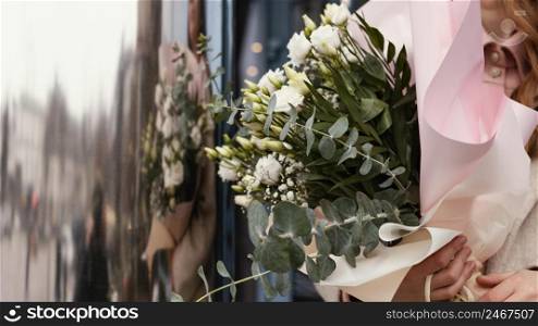 front view elegant woman outdoors holding bouquet flowers