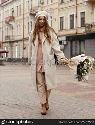front view elegant woman outdoors holding bouquet flowers spring