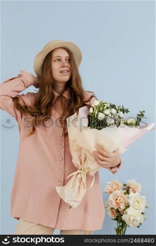 front view elegant woman posing with bouquet spring flowers