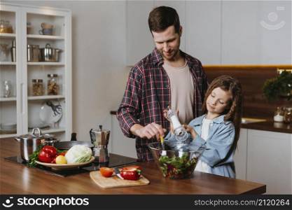 front view father with daughter preparing food kitchen