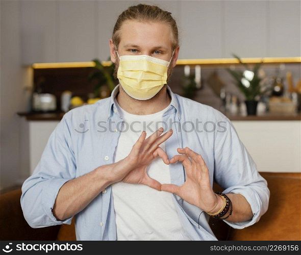 front view father with medical mask making heart sign with hands
