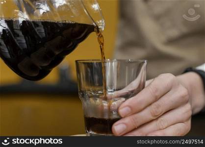 front view female barista pouring coffee transparent glass