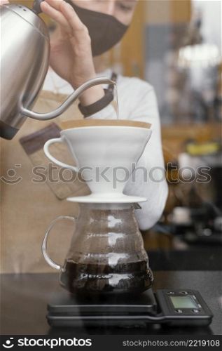 front view female barista straining coffee