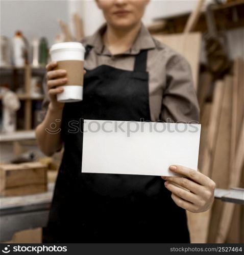 front view female carpenter holding coffee paper