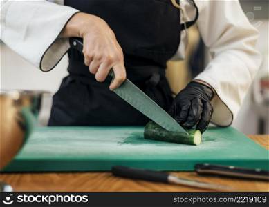 front view female chef slicing cucumber
