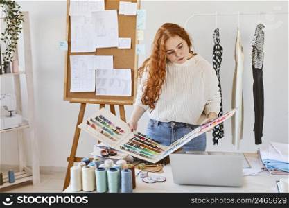 front view female fashion designer atelier with color palette