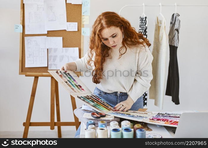 front view female fashion designer working with color palette atelier