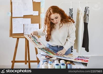 front view female fashion designer working with color palette atelier