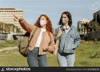 front view female friends with face masks outdoors together