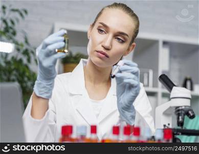 front view female researcher laboratory with microscope test tubes