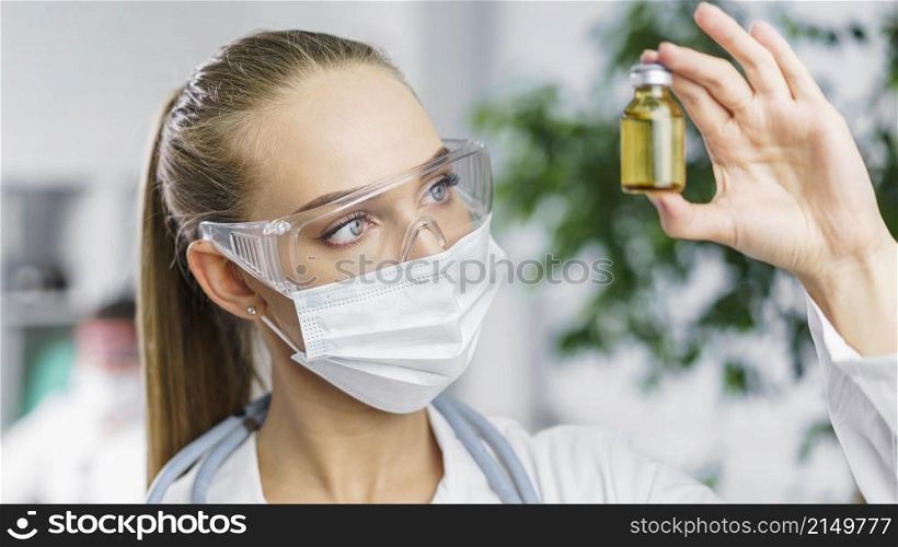 front view female researcher with medical mask vaccine