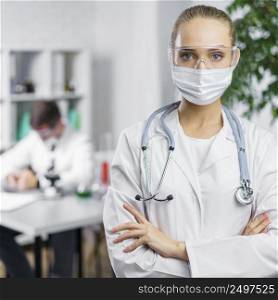 front view female researcher with stethoscope medical mask