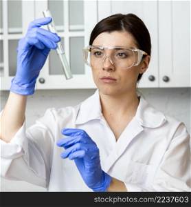 front view female researcher with test tube