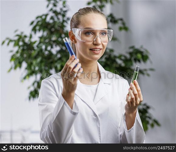 front view female researcher with test tube safety glasses