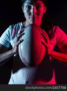 front view female rugby player holding ball
