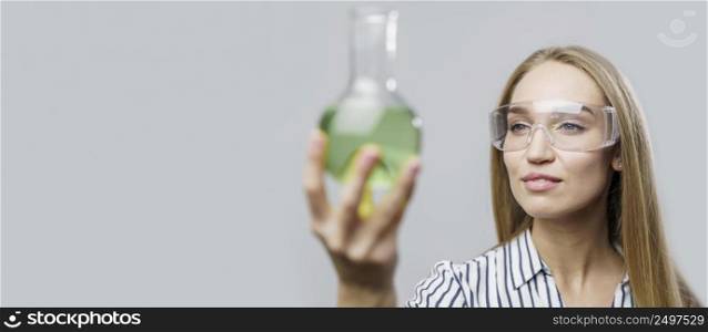 front view female scientist holding test tube with copy space
