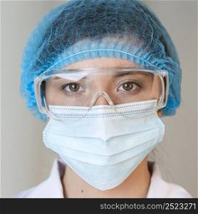 front view female scientist with safety glasses hair net medical mask