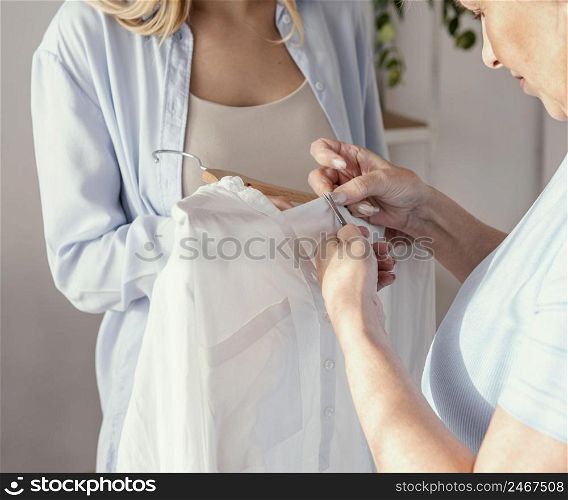 front view female seamstress choosing fabric garment