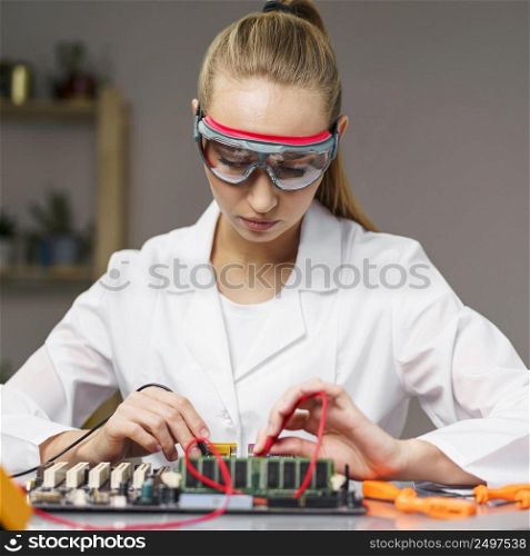 front view female technician with soldering iron electronics motherboard