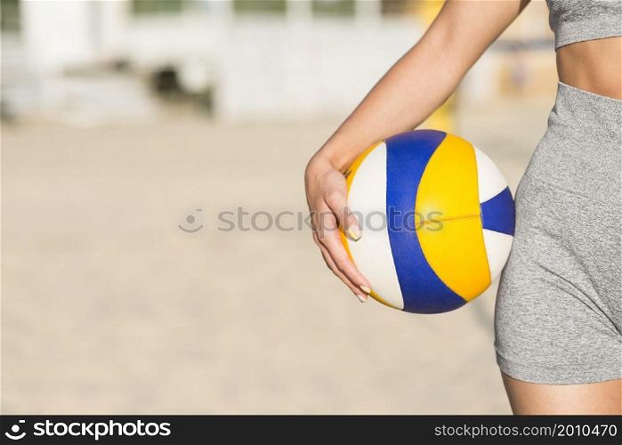 front view female volleyball player beach holding ball with copy space