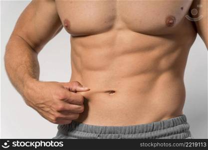 front view fit shirtless man showing abs