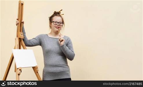 front view girl down syndrome posing easel