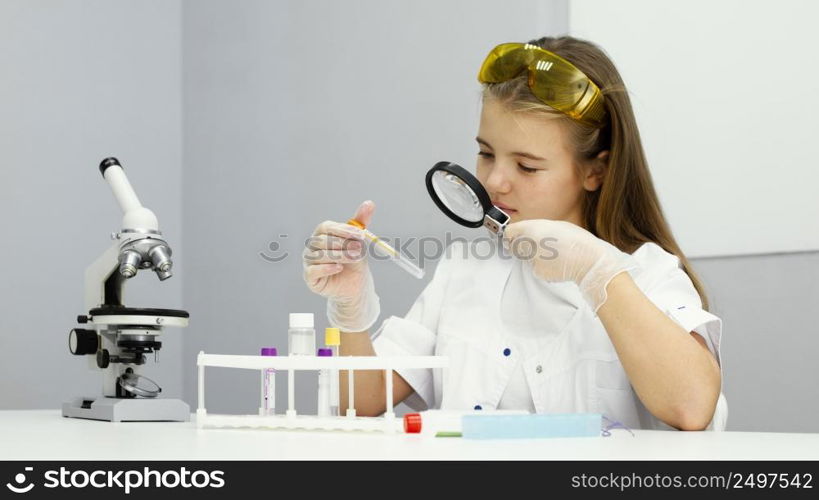 front view girl scientist with test tube magnifying glass