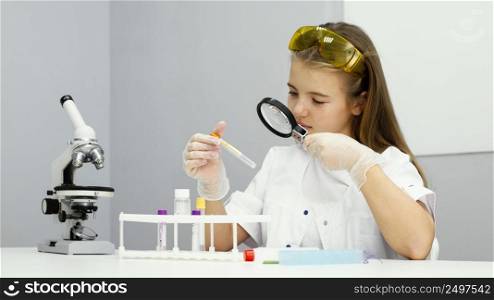front view girl scientist with test tube magnifying glass