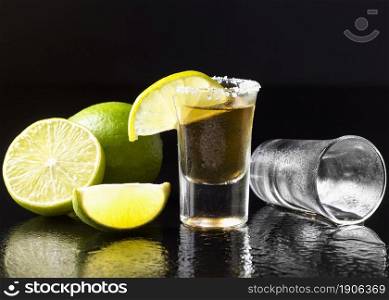 front view gold tequila shot with lime salt. High resolution photo. front view gold tequila shot with lime salt. High quality photo