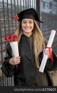 front view graduate with bouquet roses