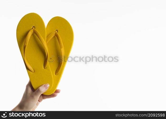 front view hand holding flip flops