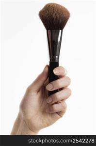 front view hand holding make up brush