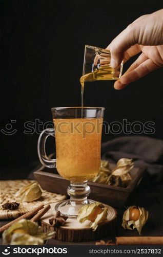 front view hand pouring honey winter hot drink