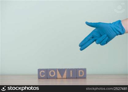 front view hand with surgical glove wooden cubes with covid