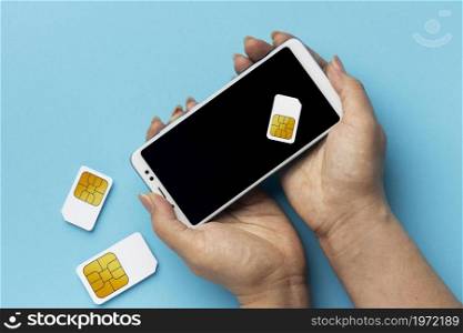 front view hands holding smartphone sim cards. High resolution photo. front view hands holding smartphone sim cards. High quality photo
