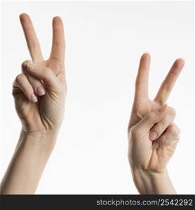 front view hands showing peace signs