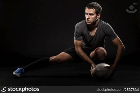 front view handsome athletic male rugby player holding ball