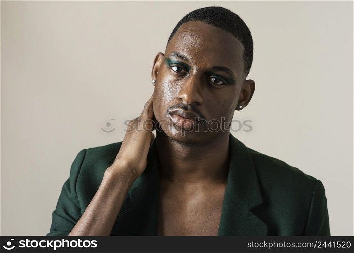 front view handsome man posing blazer wearing make up