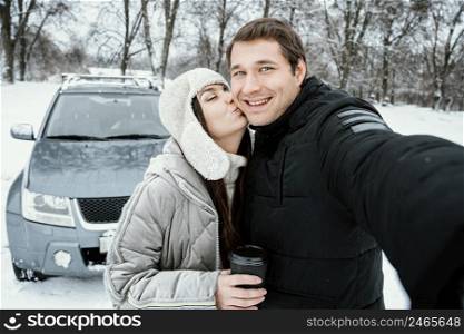 front view happy couple taking selfie while road trip