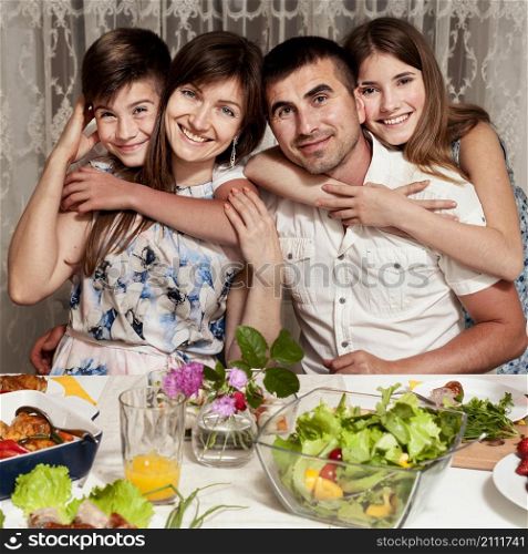 front view happy family posing dinner table